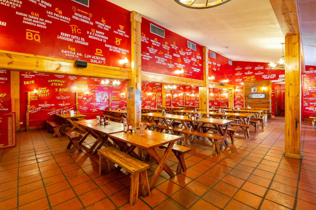 Interior of the Little Red Barn Steakhouse with its iconic cattle brands.